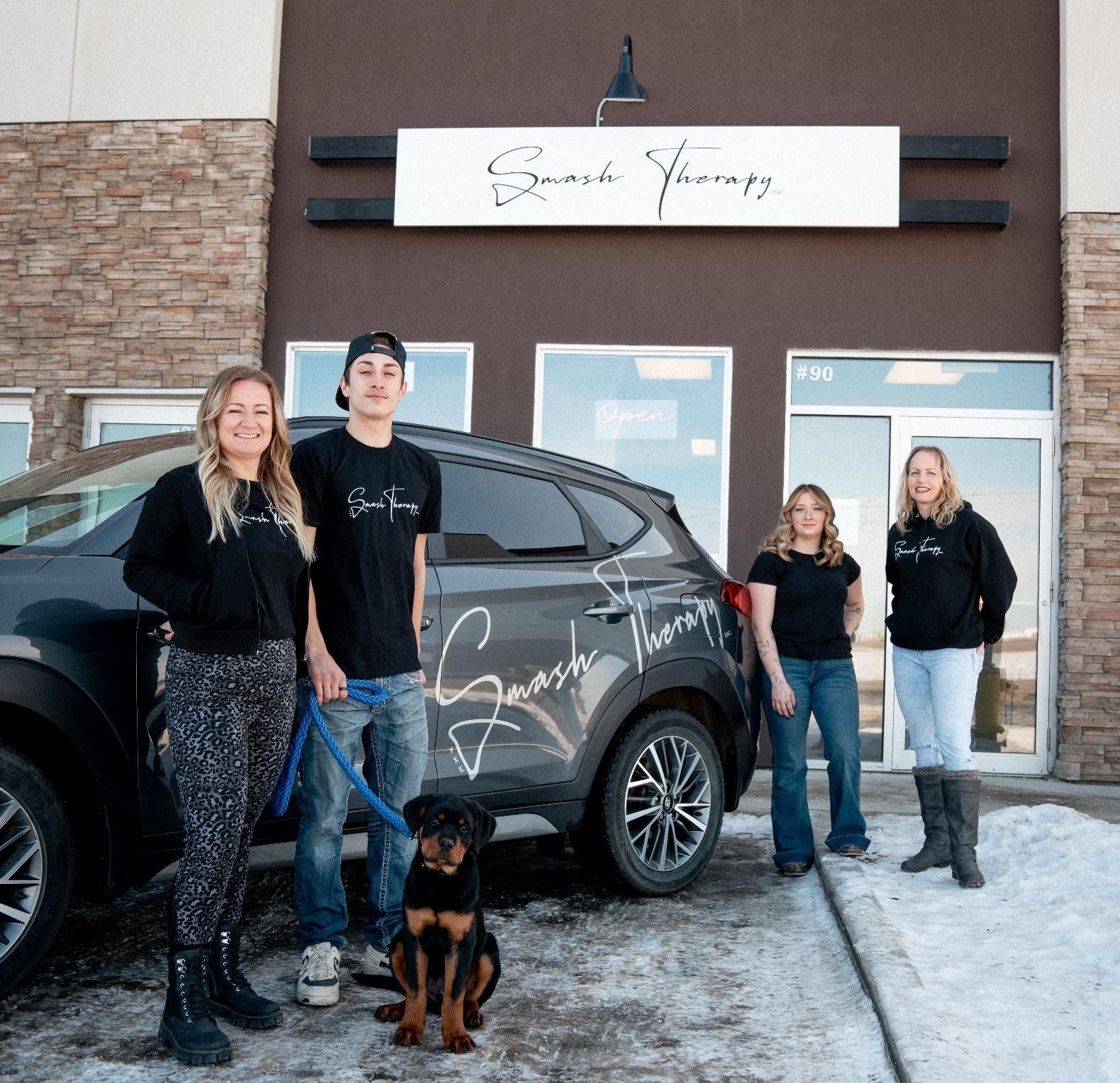 Smash Therapy team in front of building and branded vehicle